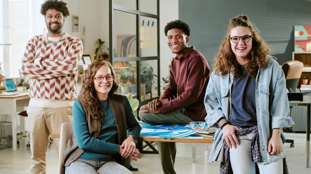 Group of creatives smiling together in a studio