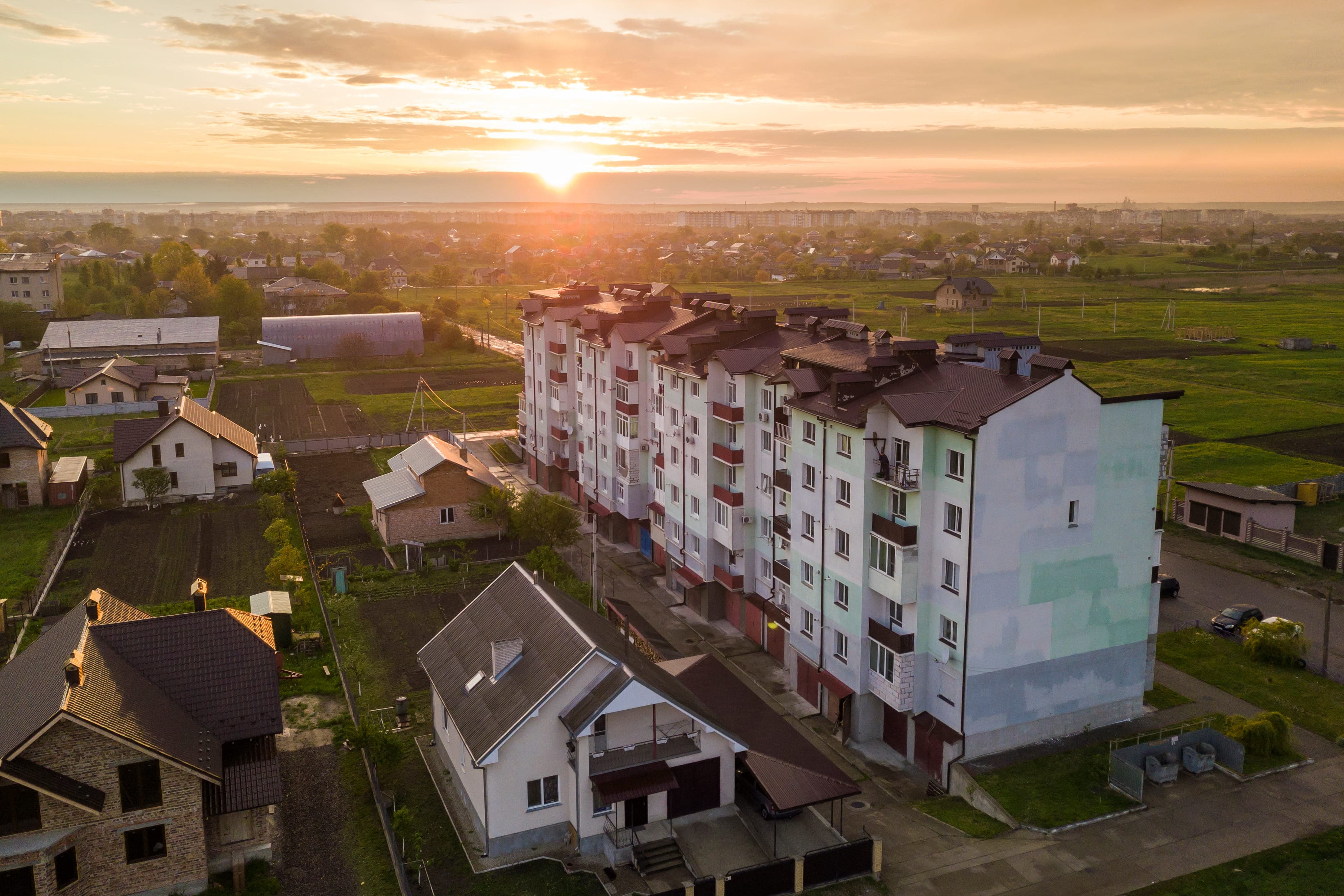 Apartment block and houses at sunset
